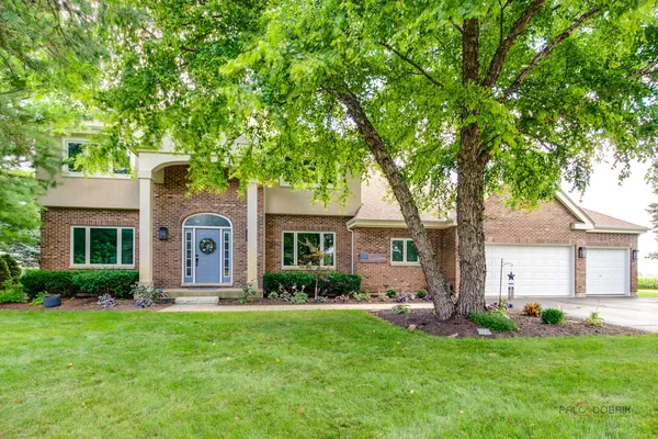 a front view of house with yard and green space