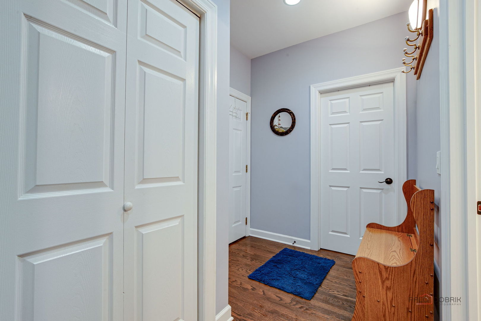3313 Ridge Road Spring Grove, IL 60081 - Photo 21 of 49 a view of a hallway to a room with wooden floor and front door