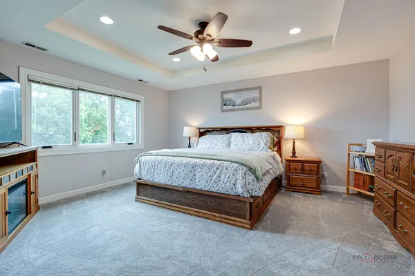 a bedroom with a bed and a chandelier