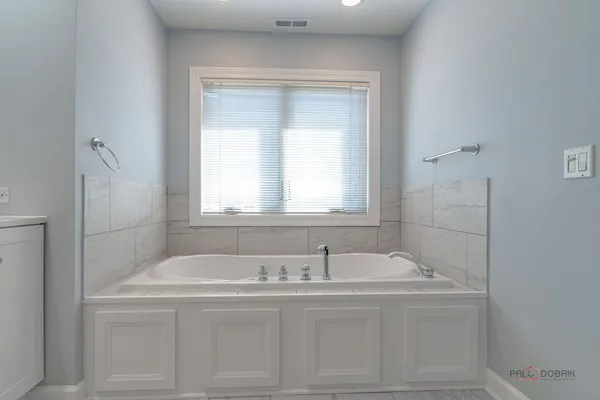 a bathroom with a bathtub and a sink