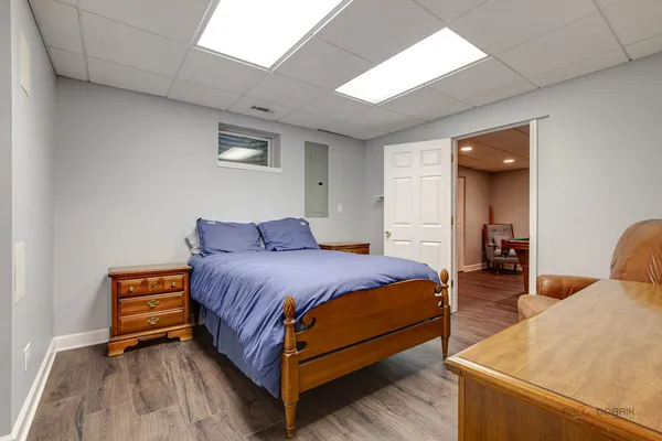 a bedroom with a bed and a lamp with window