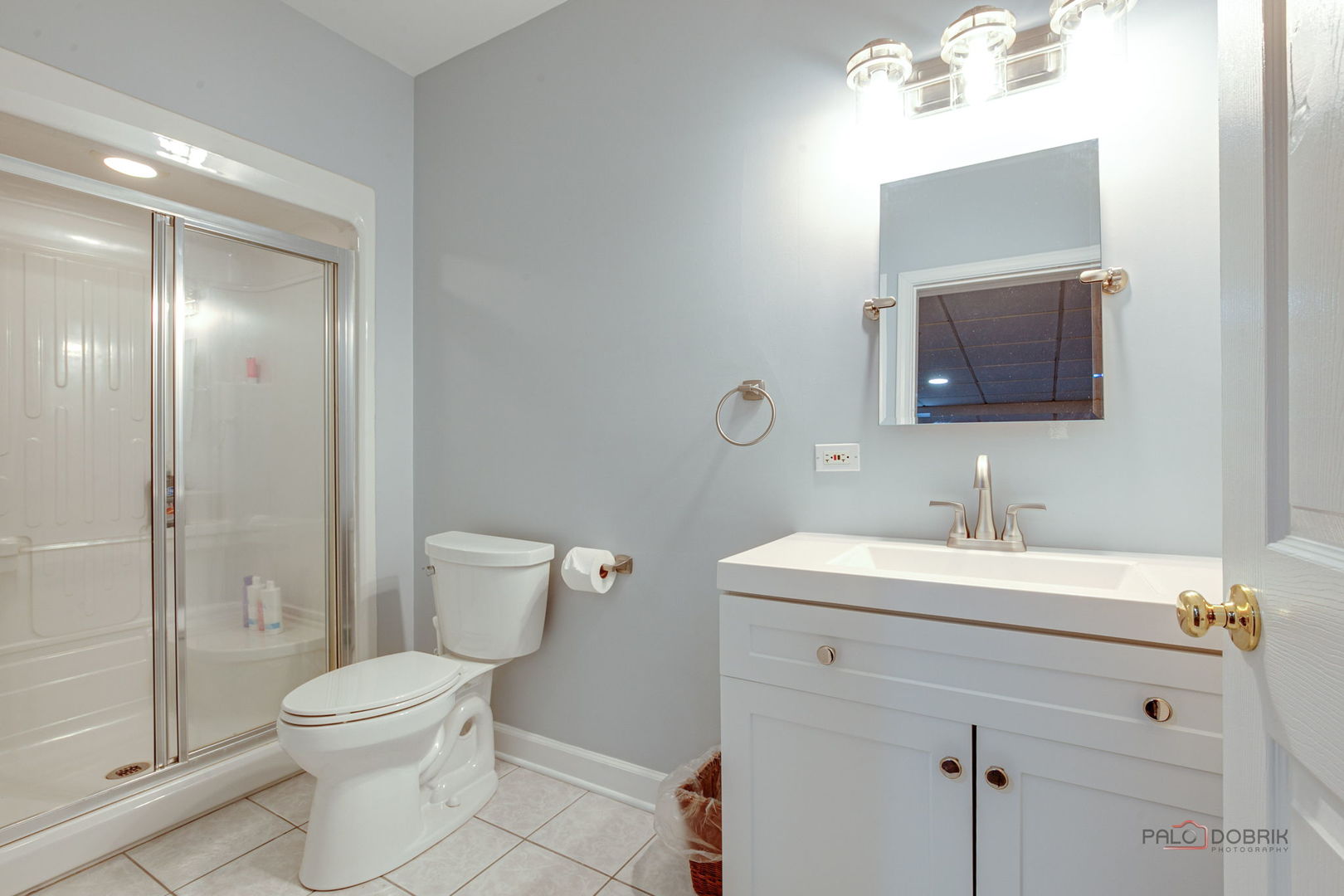 3313 Ridge Road Spring Grove, IL 60081 - Photo 40 of 49 a bathroom with a toilet a sink a mirror and shower