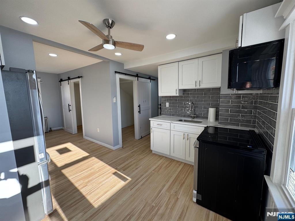 166 Rutherford Place, Unit 2 North Arlington, NJ 07031 - Photo 2 of 10 a kitchen with a sink stove and refrigerator