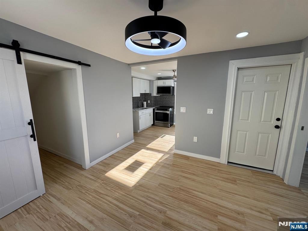 166 Rutherford Place, Unit 2 North Arlington, NJ 07031 - Photo 6 of 10 a area with wooden floor and chandelier