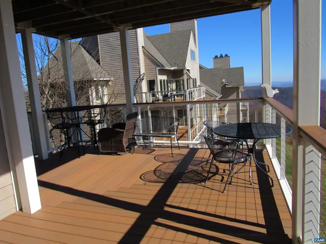 a view of a balcony dining area with furniture