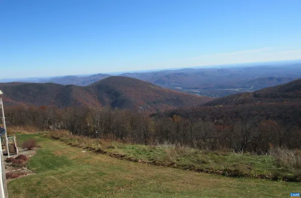 a view of a yard with a mountain
