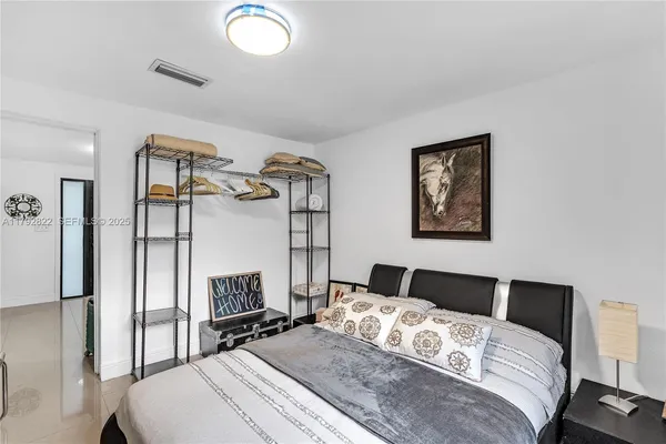 a bedroom with a bed and a lamp