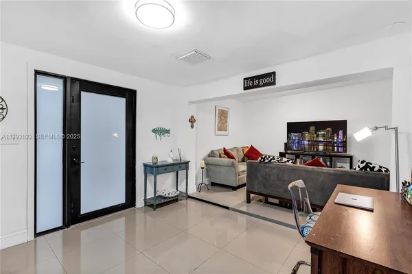 a living room with furniture and a flat screen tv