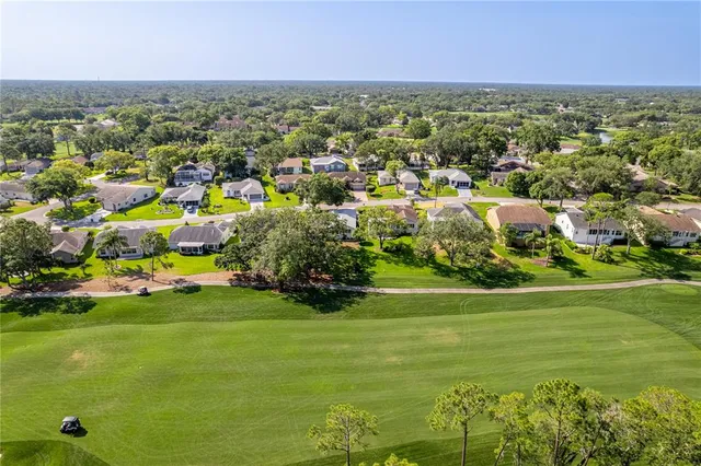 an aerial view of a houses with a lake view