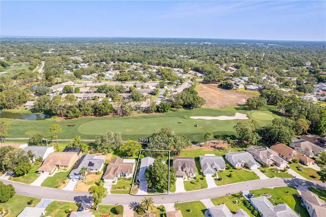 an aerial view of residential houses with outdoor space and river