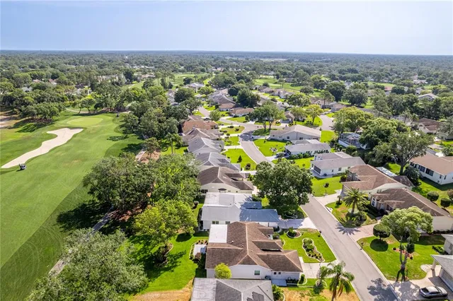 a dining room with furniture and a large window