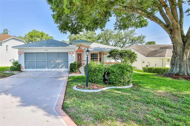 an aerial view of a city with lots of residential buildings and mountain view in back