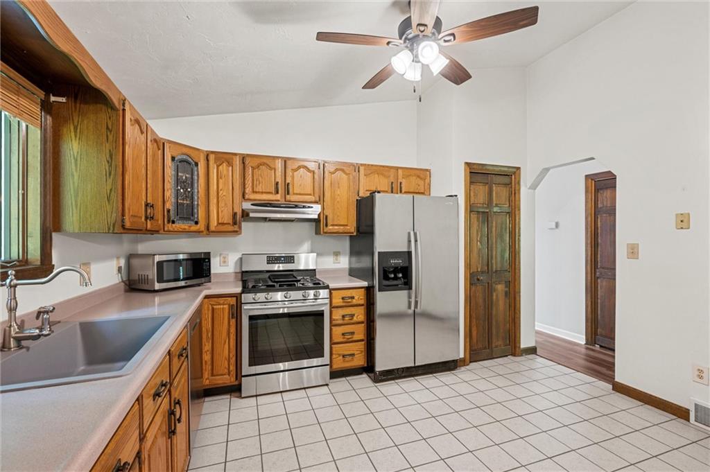 210 Arner Road Freeport, PA 16229 - Photo 10 of 40 a kitchen with stainless steel appliances granite countertop a stove refrigerator sink and microwave