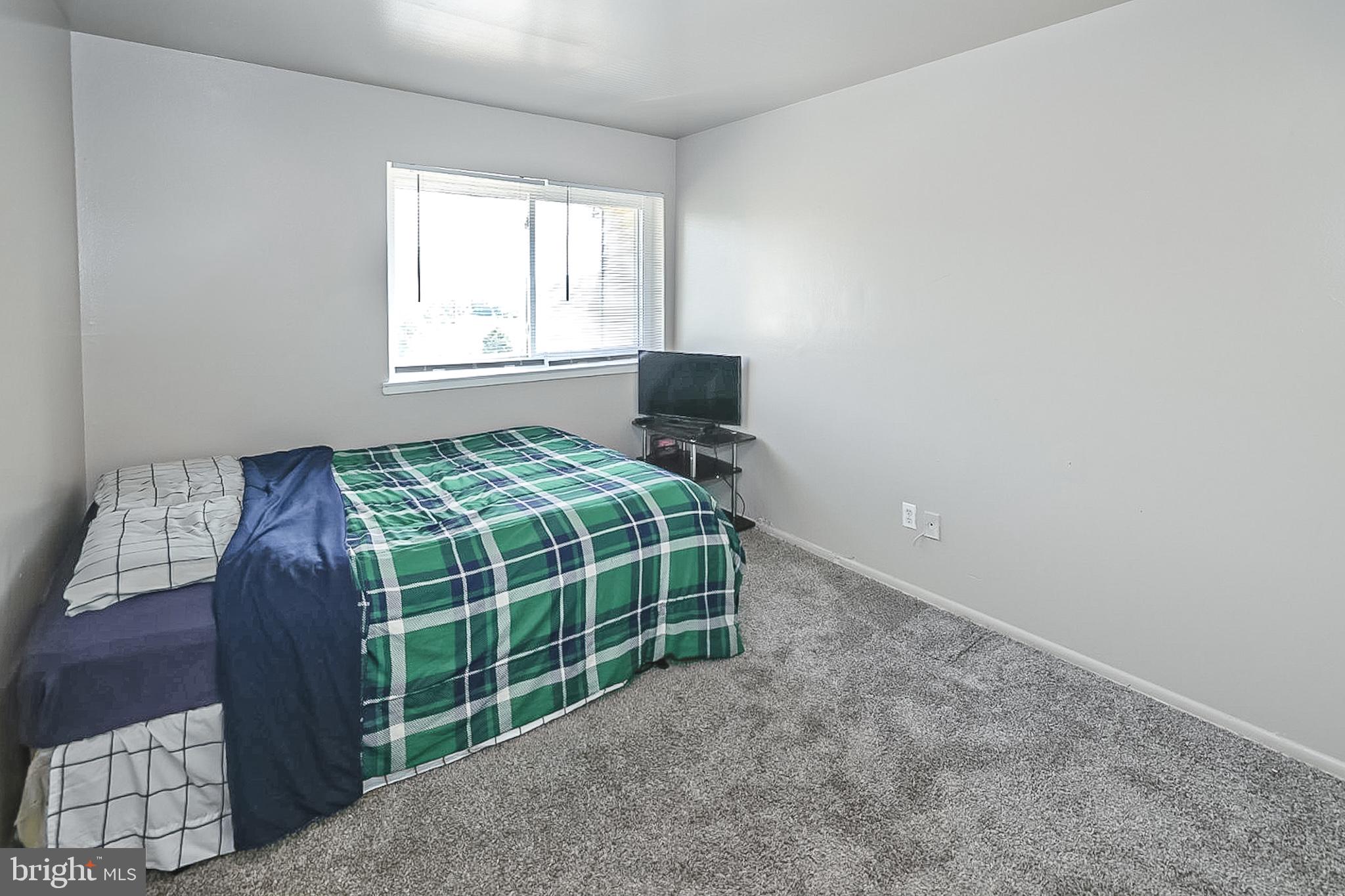 10214 Prince Place, Unit 8202 Upper Marlboro, MD 20774 - Photo 15 of 22 a bedroom with a bed and a window