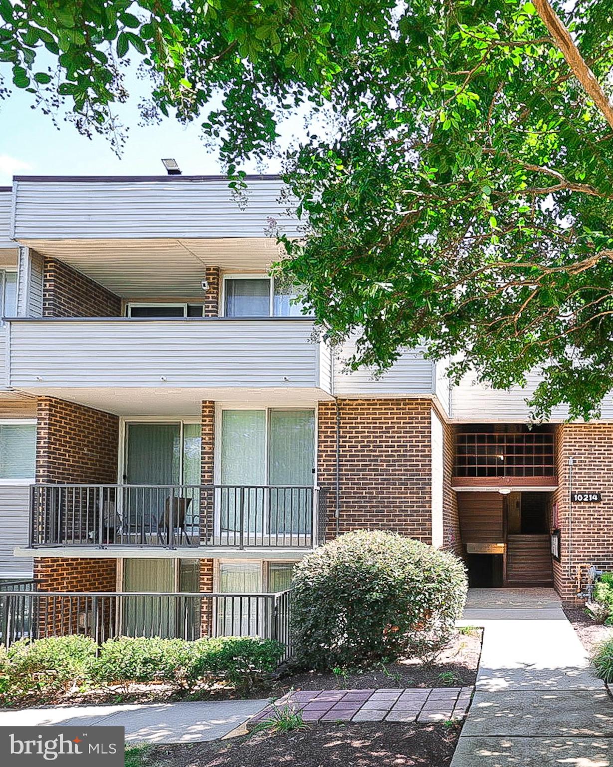 10214 Prince Place, Unit 8202 Upper Marlboro, MD 20774 - Photo 2 of 22 a front view of a house with a garden