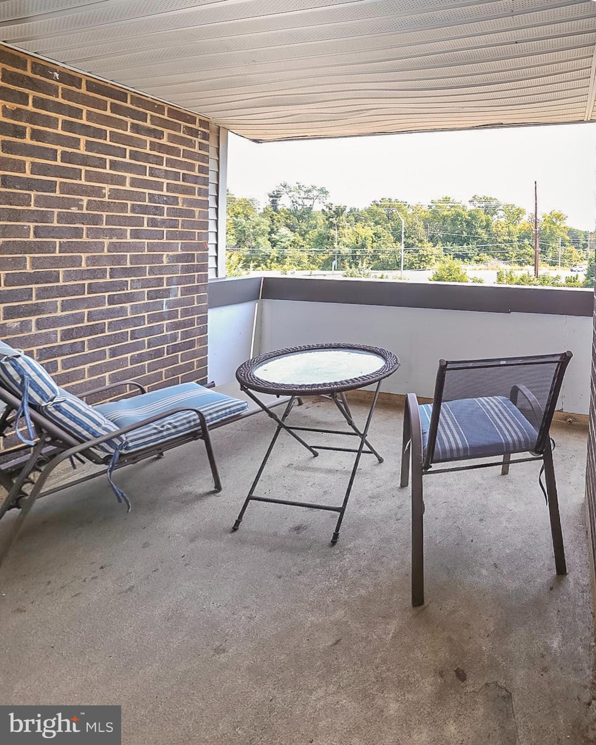 10214 Prince Place, Unit 8202 Upper Marlboro, MD 20774 - Photo 21 of 22 a view of a chairs and table in the terrace