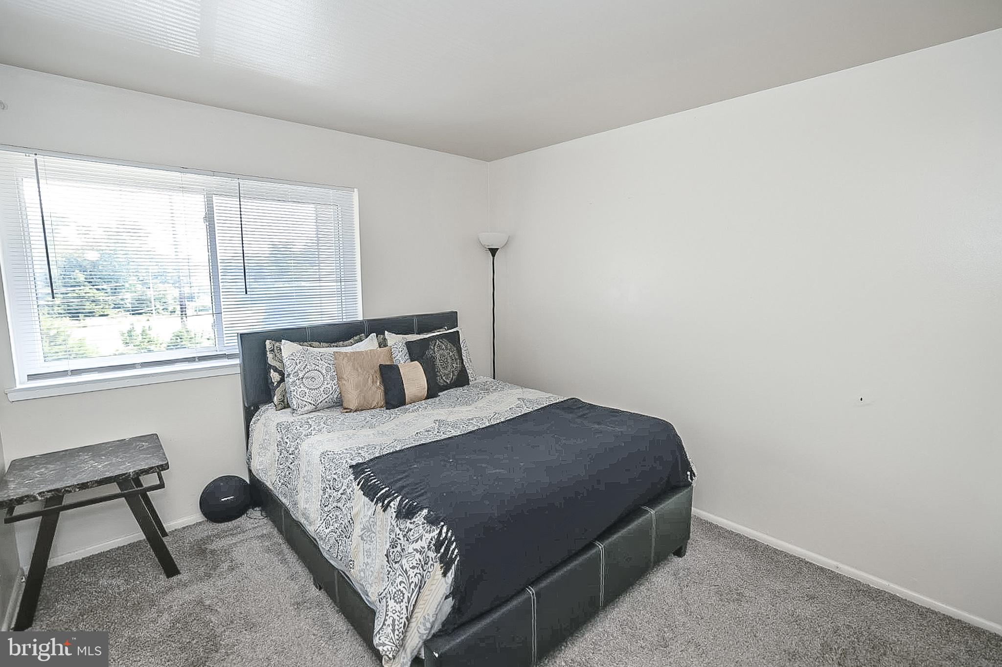 10214 Prince Place, Unit 8202 Upper Marlboro, MD 20774 - Photo 22 of 22 a bedroom with a bed and window