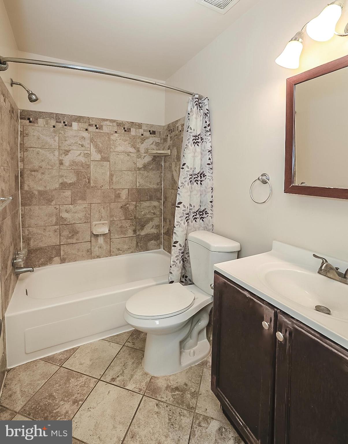 10214 Prince Place, Unit 8202 Upper Marlboro, MD 20774 - Photo 10 of 22 a bathroom with a sink toilet and shower