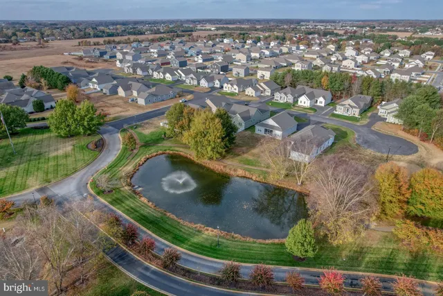 an aerial view of a house with a yard basket ball court and outdoor seating