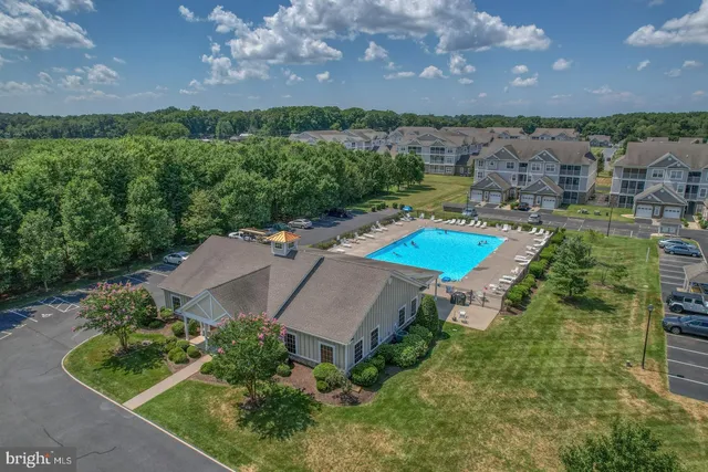 an aerial view of a house with outdoor space swimming pool and lake view