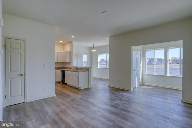 a view of kitchen with refrigerator and wooden floor