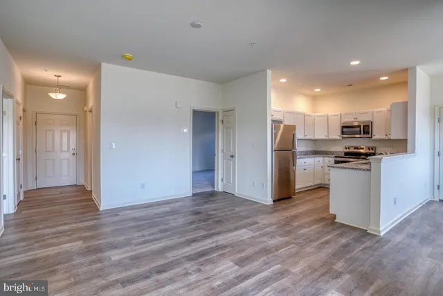 a view of kitchen view wooden floor and electronic appliances