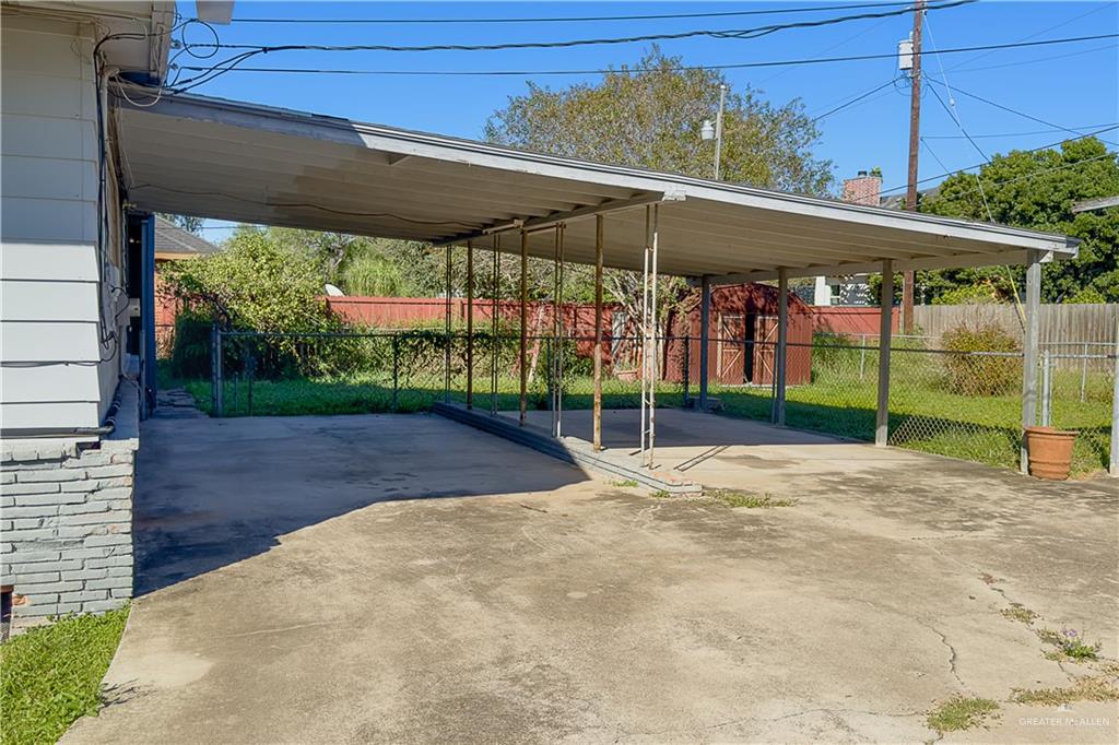 706 West 10th Street Weslaco, TX 78596 - Photo 11 of 14 a view of a patio with a table and chairs under an umbrella