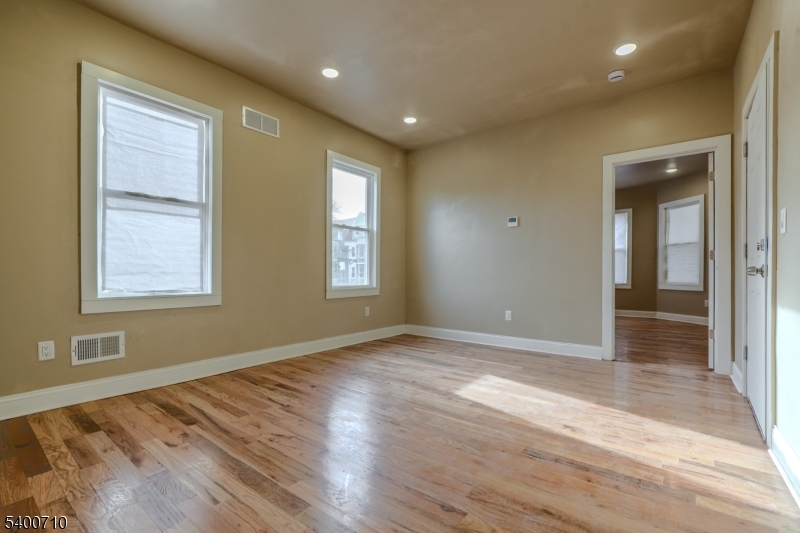 882 South 14th Street, Unit 1 Newark, NJ 07108 - Photo 13 of 17 a view of empty room with wooden floor and fan