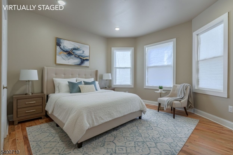 882 South 14th Street, Unit 1 Newark, NJ 07108 - Photo 3 of 17 a bedroom with a bed and wooden floor