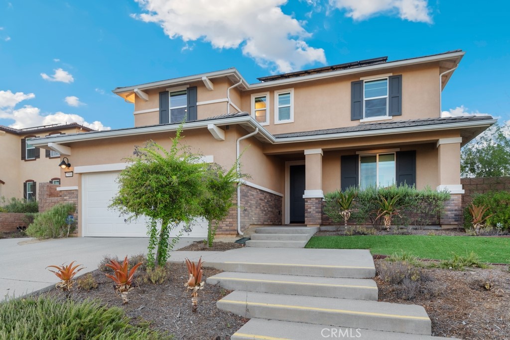 25066 Ridgemoor Road Menifee, CA 92584 - Photo 1 of 1 a front view of a house with garden and plants