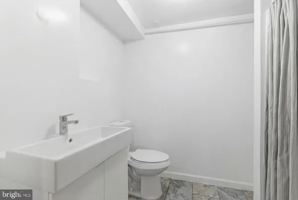 a bathroom with a glass shower door