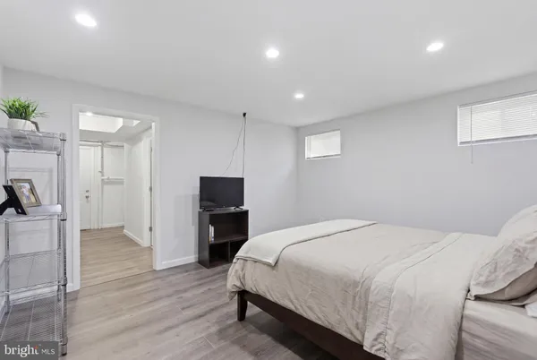 a room with a bed and a wooden floor