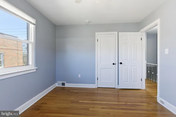 a view of a room with wooden floor and windows