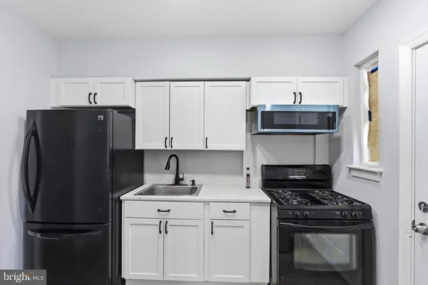 a kitchen with stainless steel appliances a refrigerator and a stove