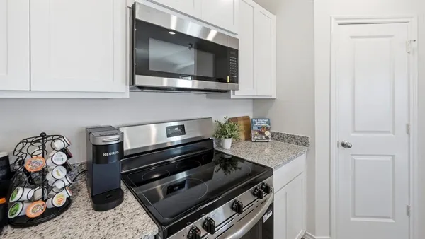 a kitchen with a stove and a microwave