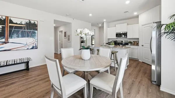 a dining room with furniture and wooden floor