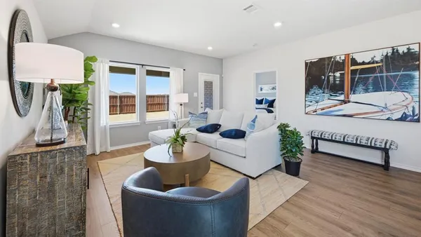 a living room with furniture and wooden floor