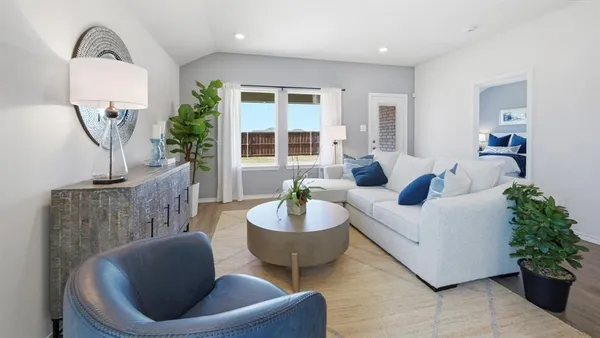 a living room with furniture and a potted plant