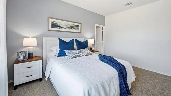 a bedroom with a bed and a night stand