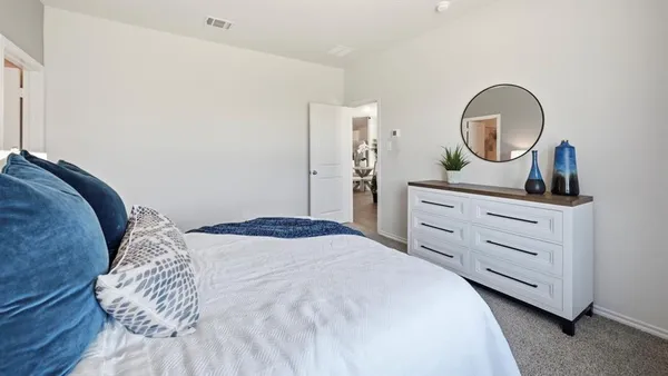 a bedroom with a bed and a dresser