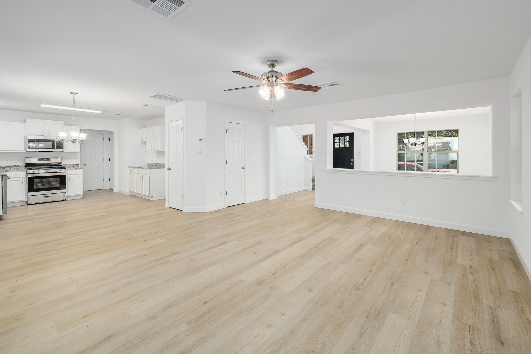 709 Los Robles Road Leander, TX 78641 - Photo 6 of 26 Open-concept living area boasts new flooring, a bright kitchen, and a dining nook.