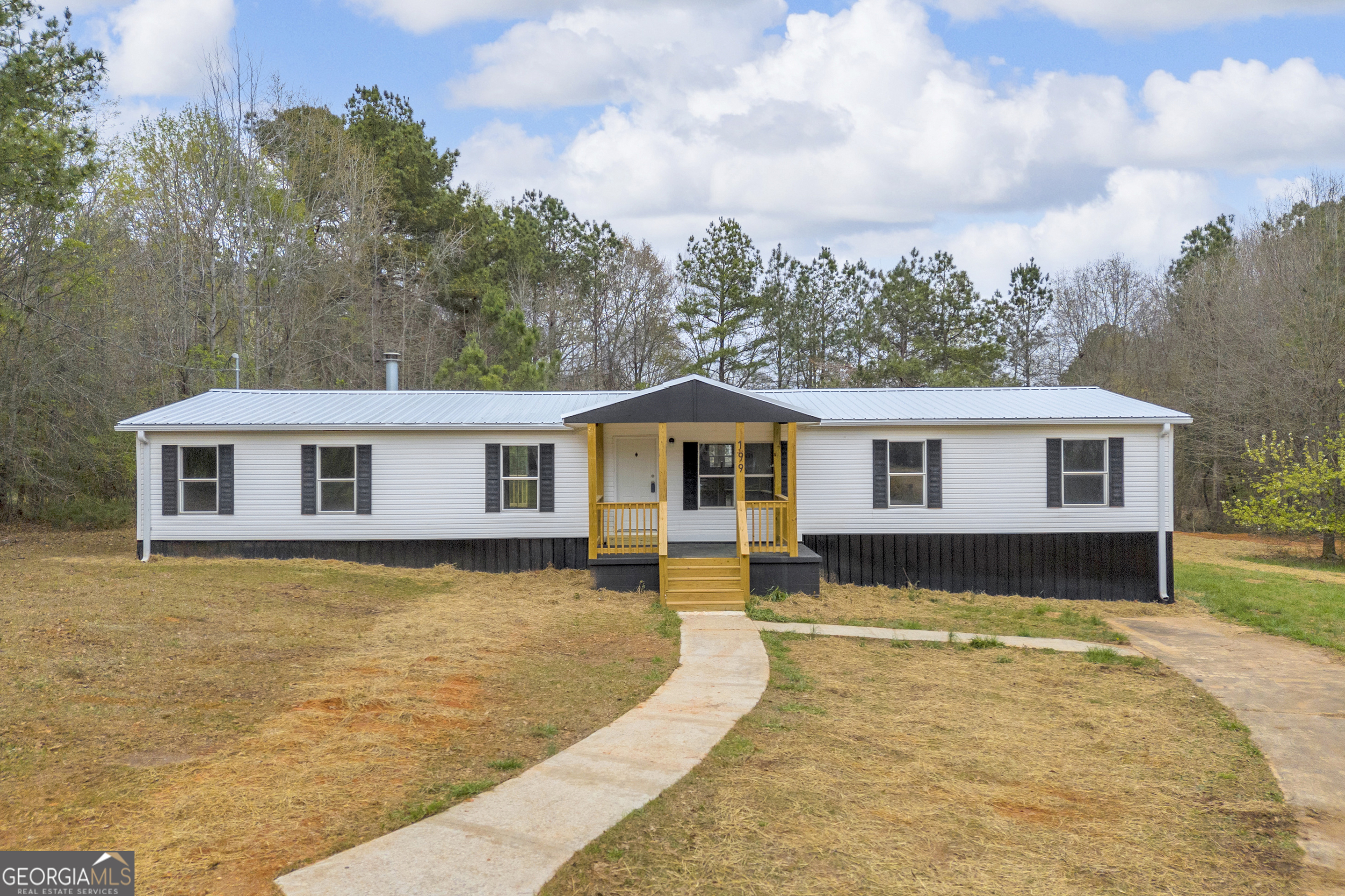 a view of a house with a yard covered in snow