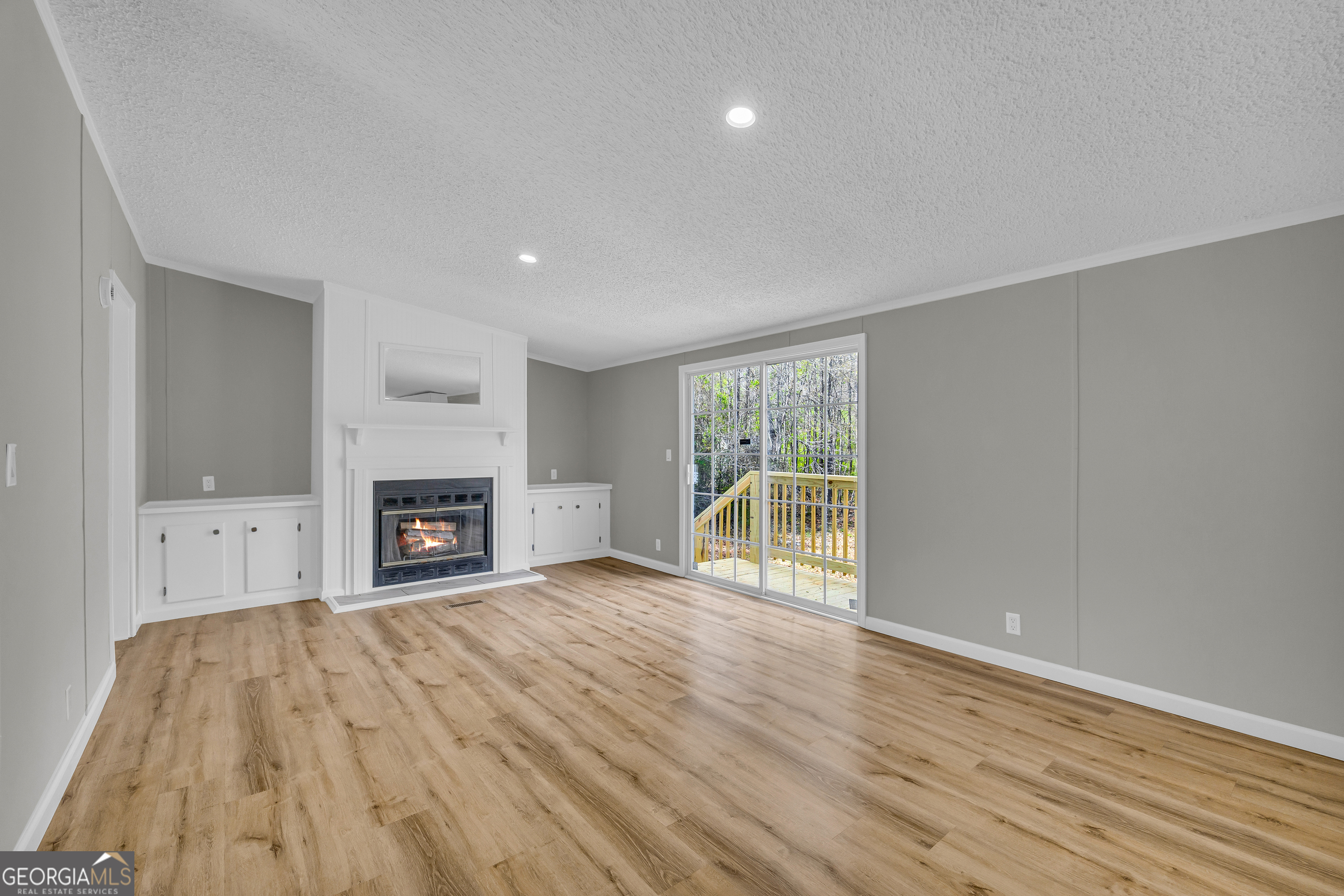 199 Alberta Drive Colbert, GA 30628 - Photo 13 of 39 a view of empty room with wooden floor and fireplace