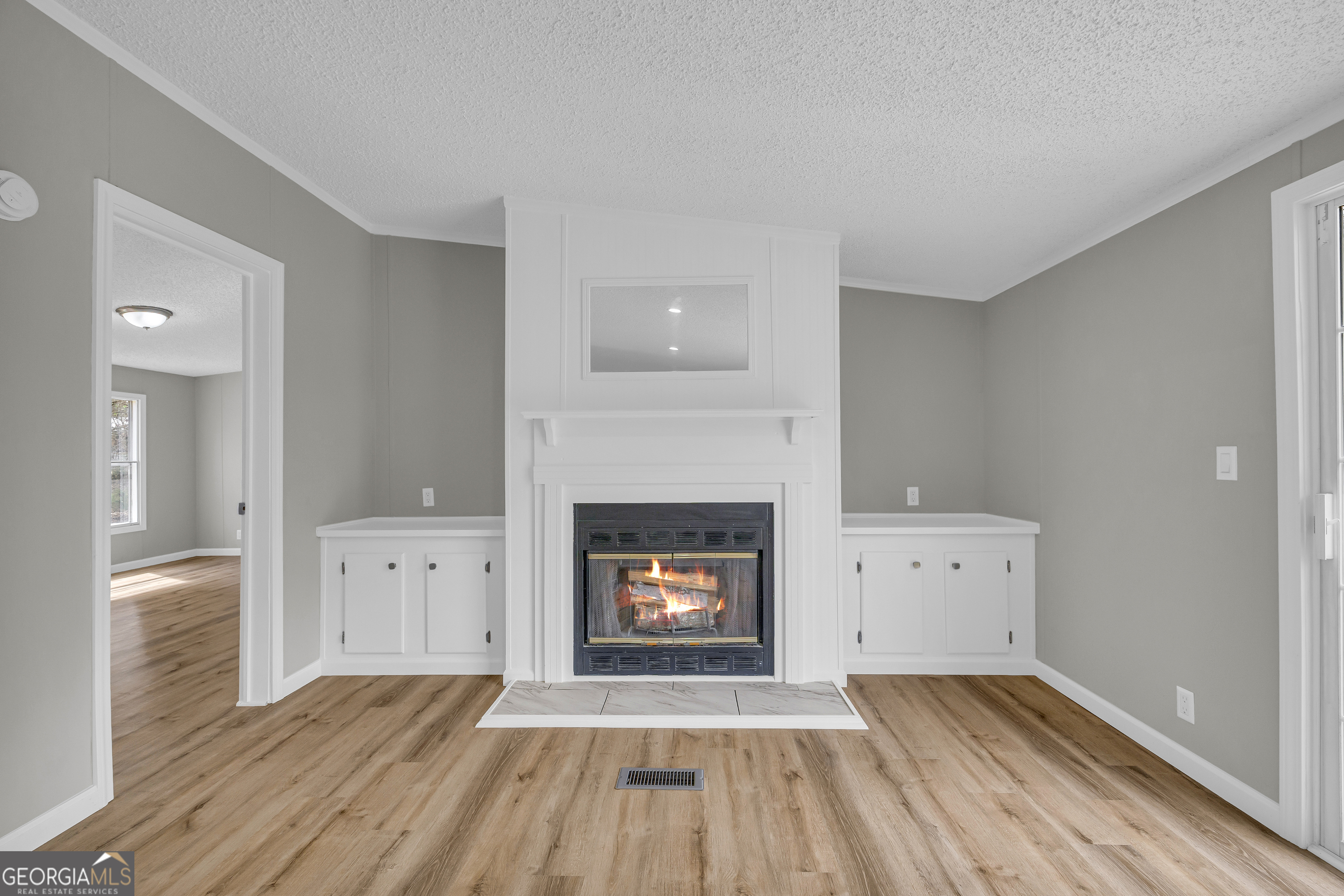 199 Alberta Drive Colbert, GA 30628 - Photo 14 of 39 wooden floor fireplace and natural light