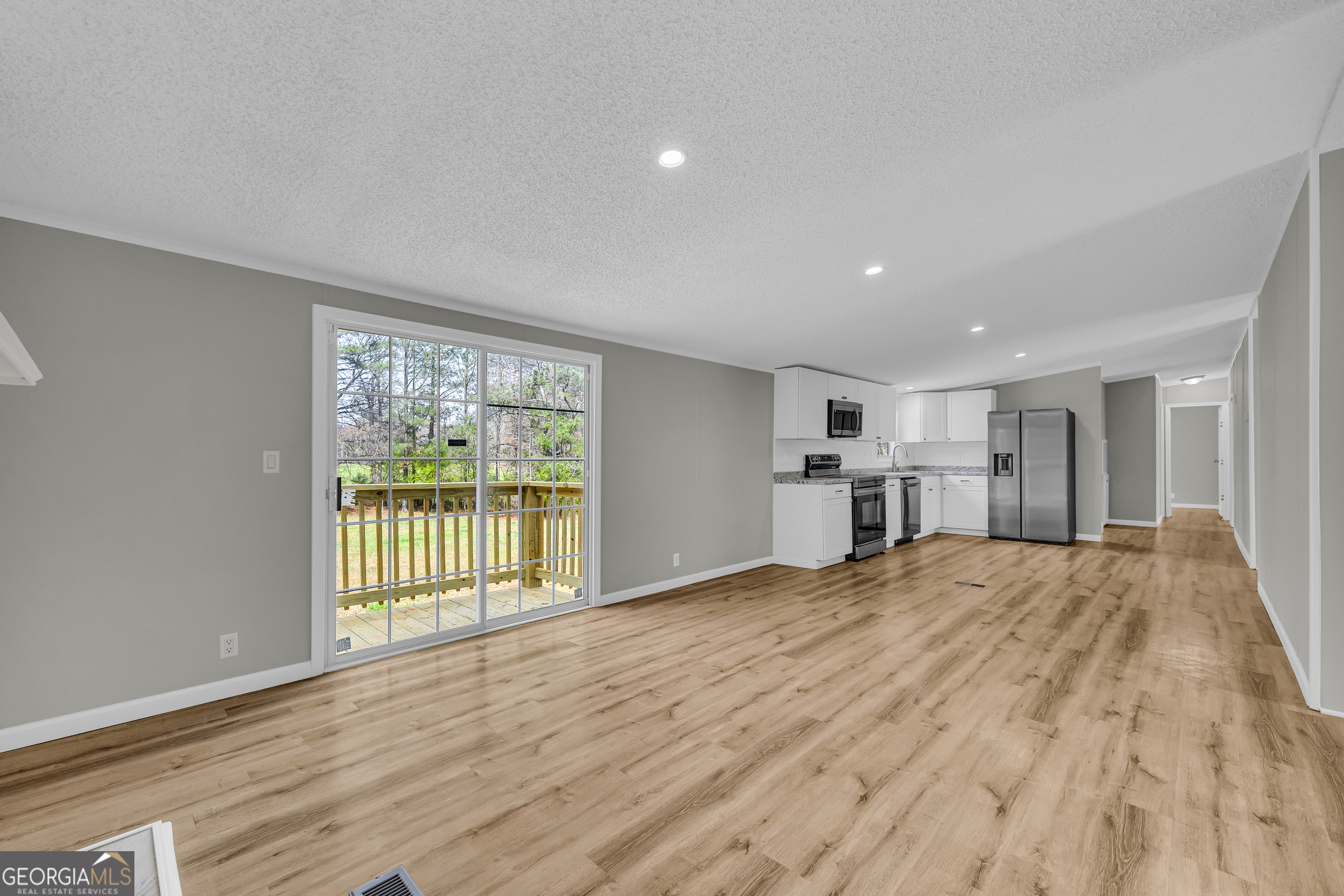 199 Alberta Drive Colbert, GA 30628 - Photo 20 of 39 a view of an empty room with wooden floor and a window
