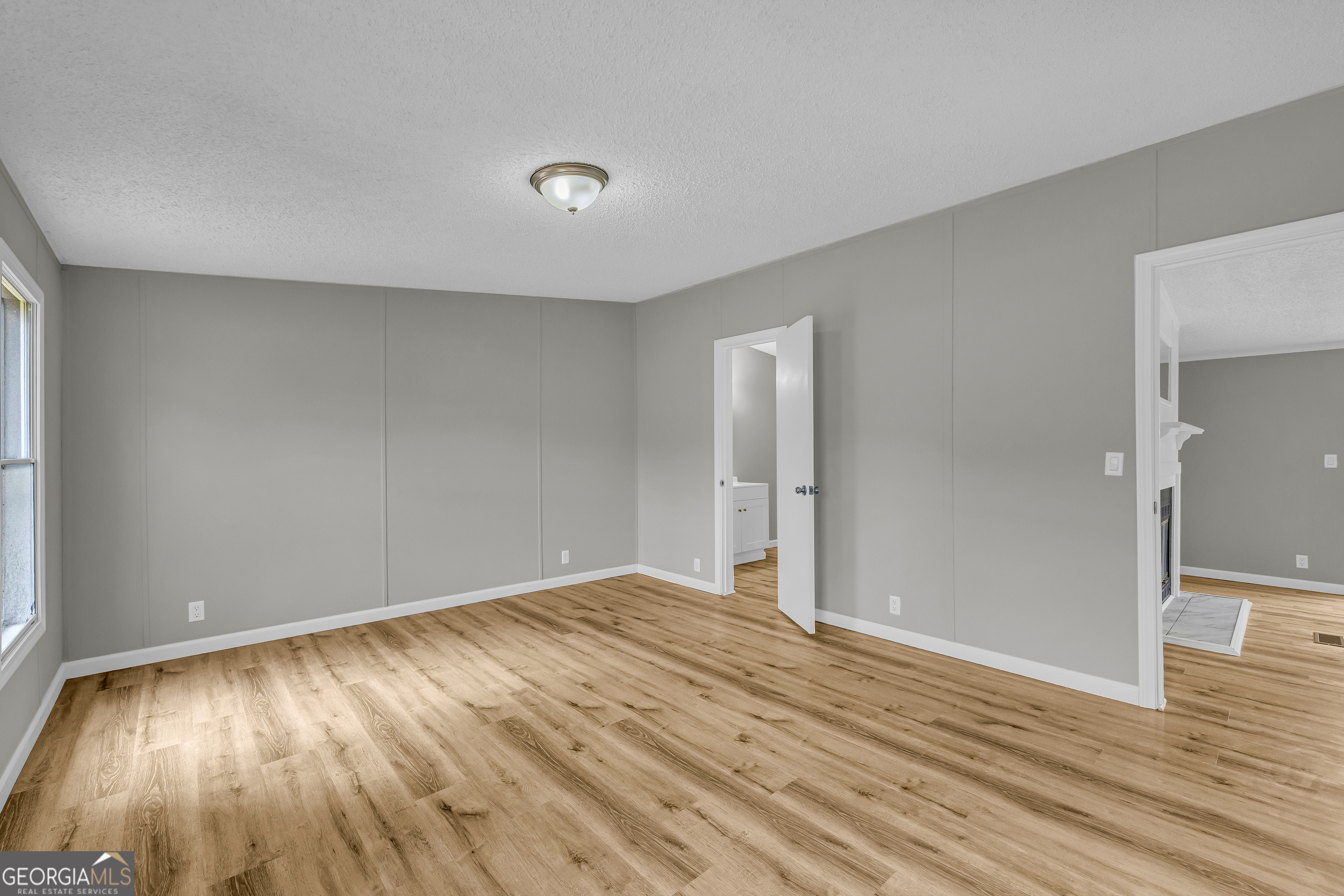 199 Alberta Drive Colbert, GA 30628 - Photo 23 of 39 a view of an empty room with wooden floor and a window