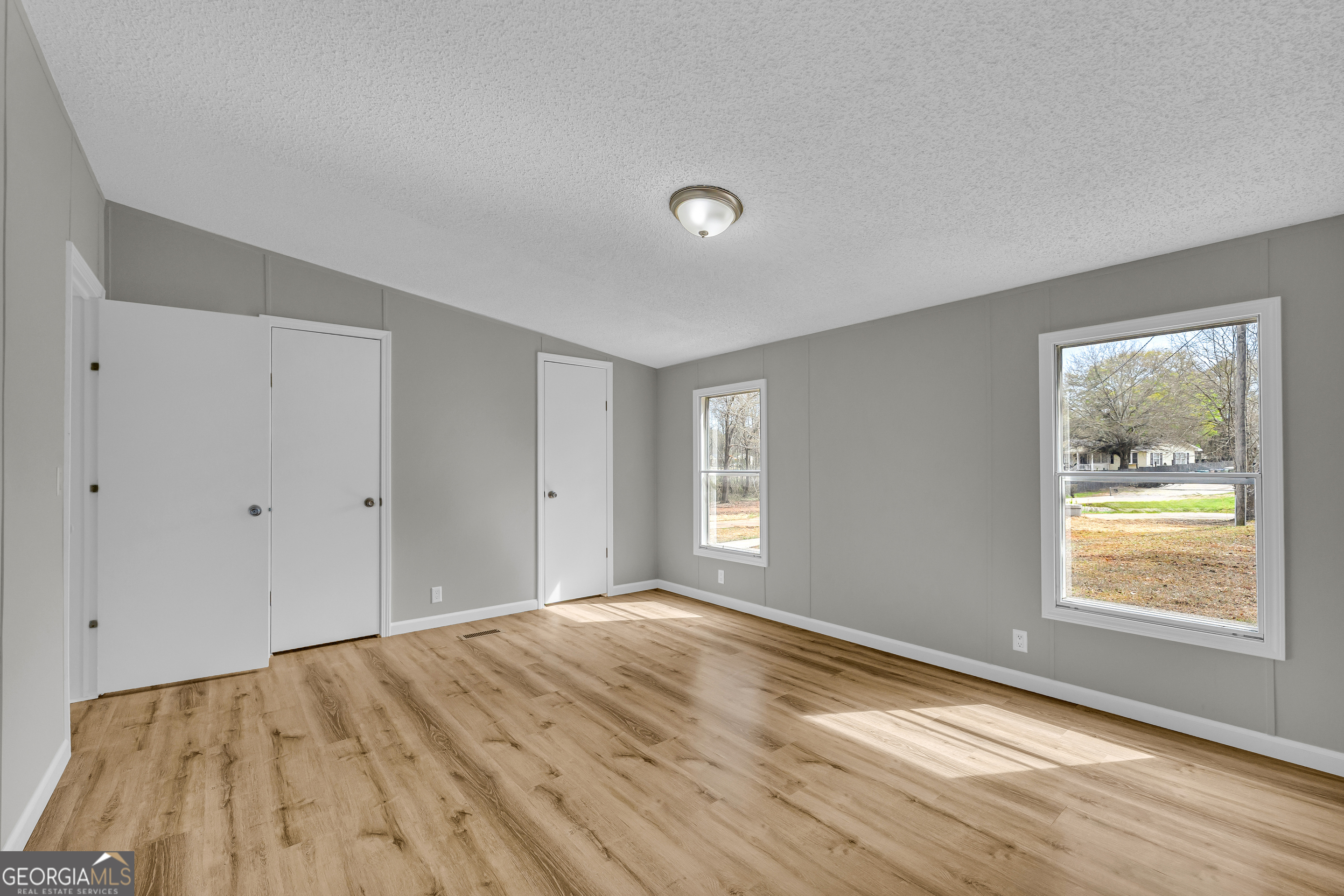 199 Alberta Drive Colbert, GA 30628 - Photo 25 of 39 a view of an empty room with wooden floor and a window