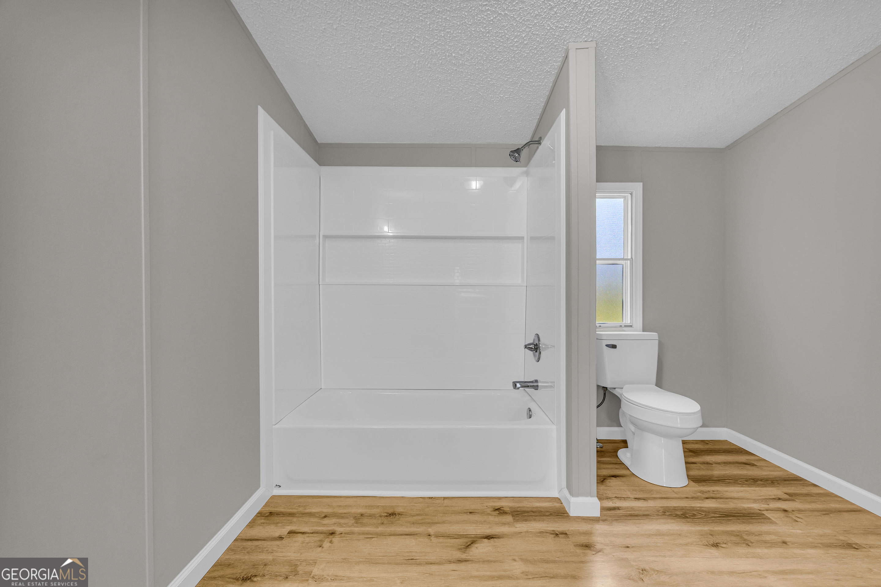 199 Alberta Drive Colbert, GA 30628 - Photo 27 of 39 a bathroom with a toilet and a shower