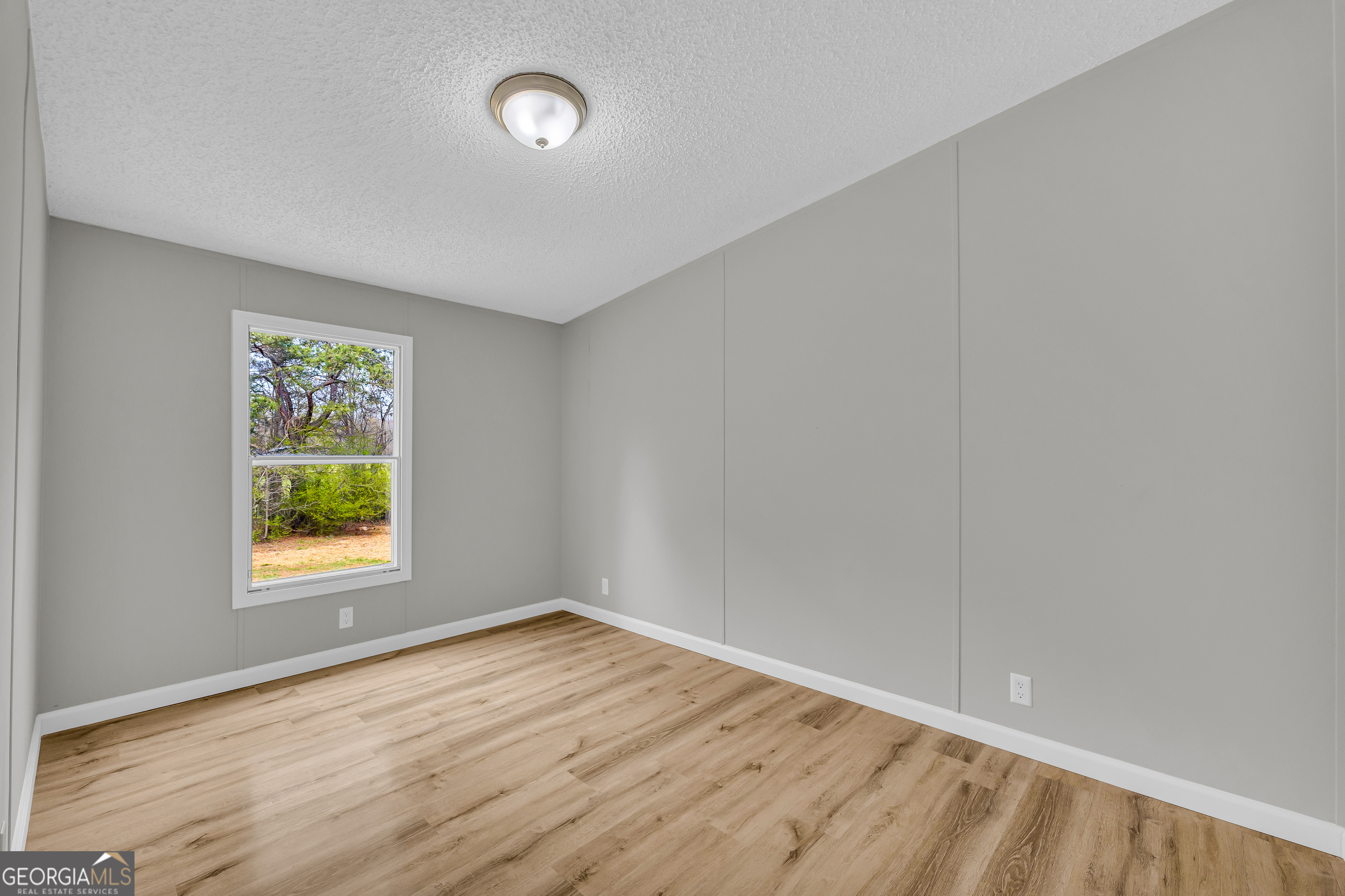 199 Alberta Drive Colbert, GA 30628 - Photo 30 of 39 wooden floor in an empty room with a window