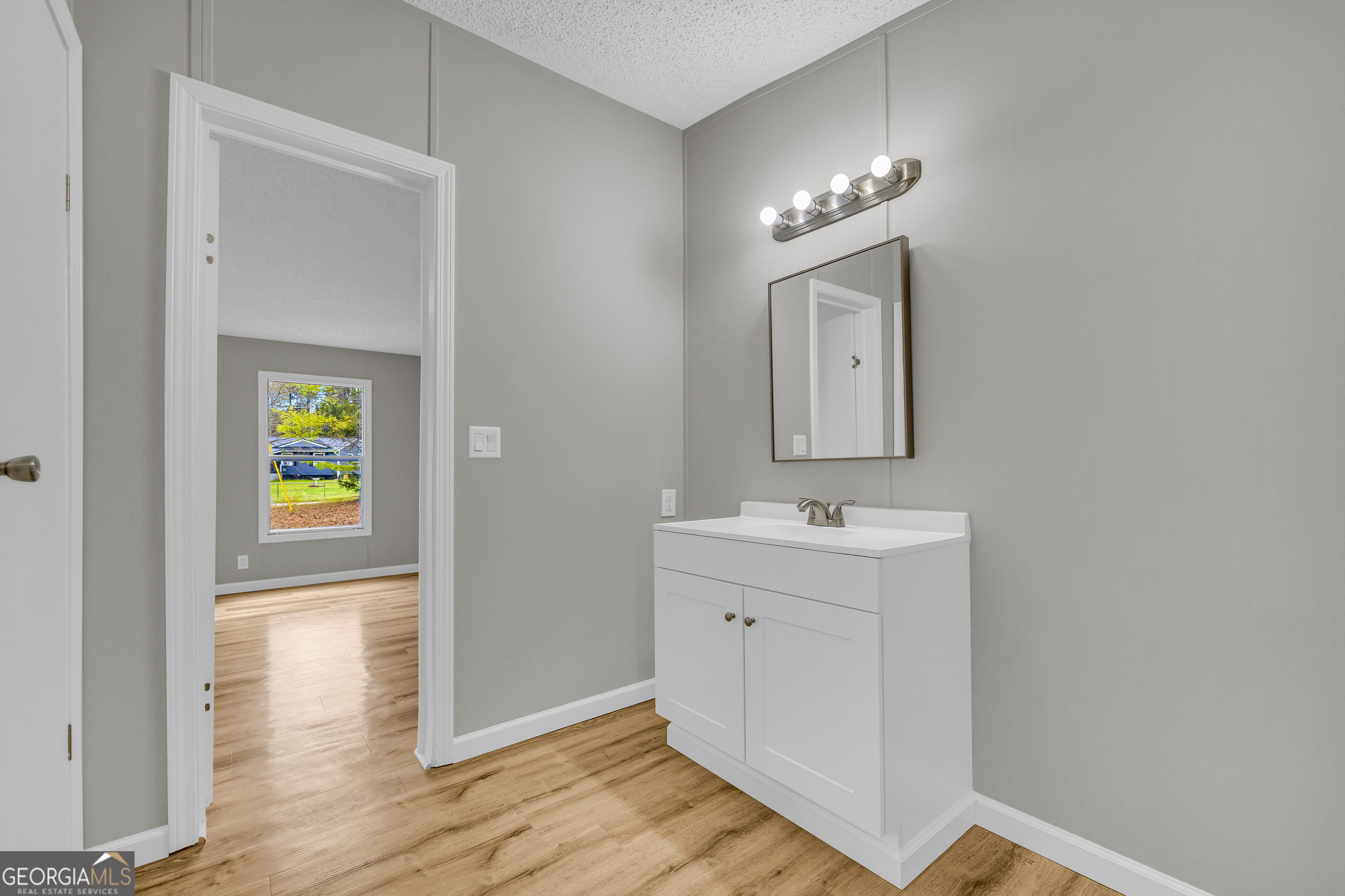 199 Alberta Drive Colbert, GA 30628 - Photo 35 of 39 a bathroom with a sink and a mirror
